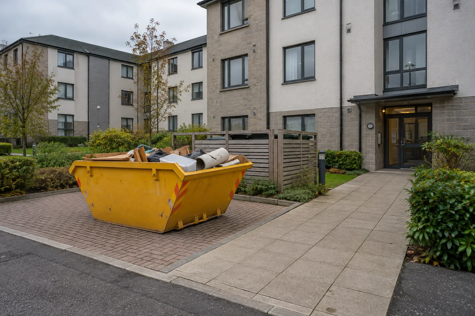 Yellow skip on a clear private driveway