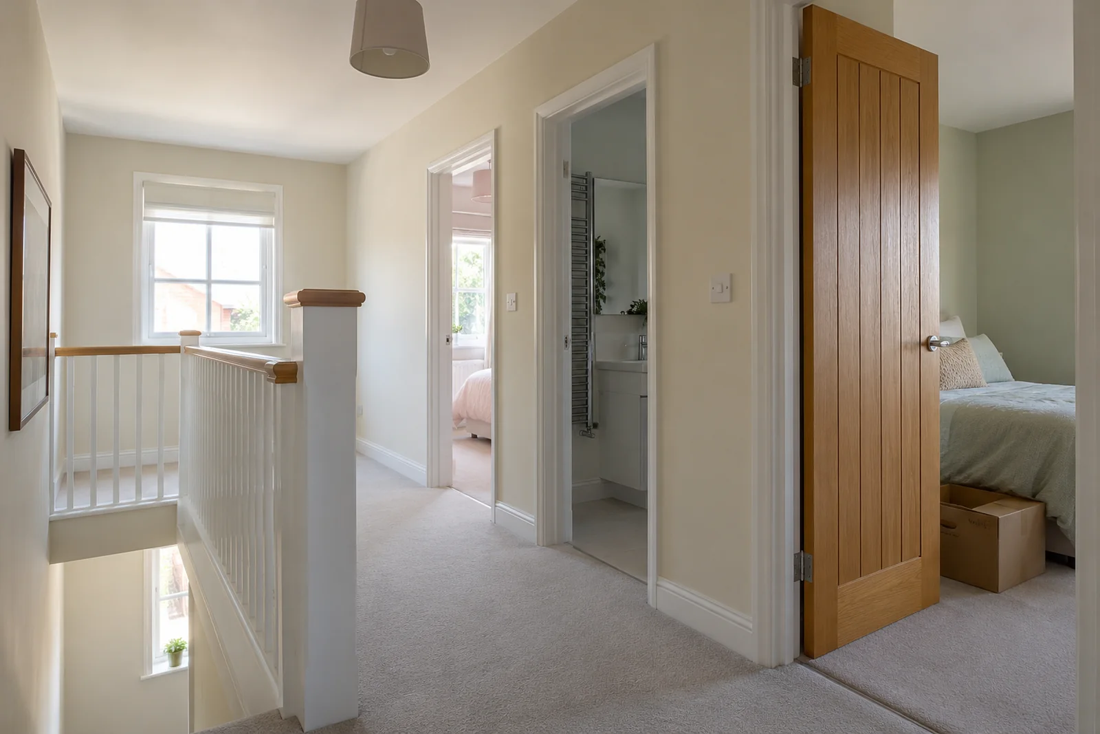 Clear upstairs landing with boxes kept inside a bedroom