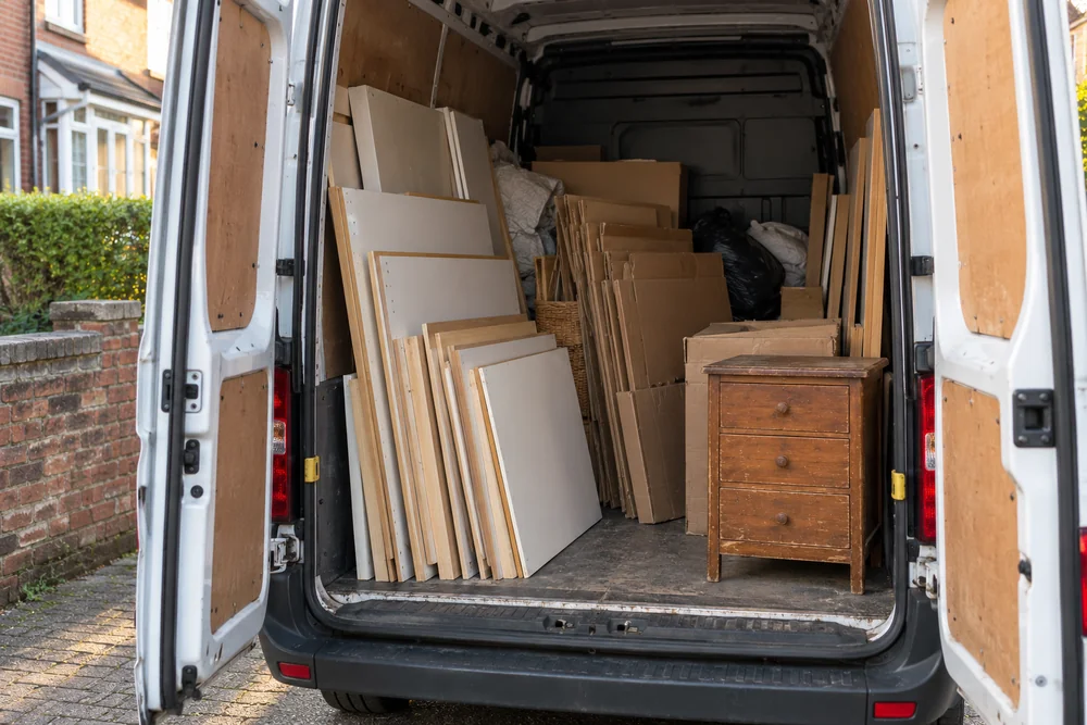 Open rear of an unbranded van containing neatly loaded household clear-out waste